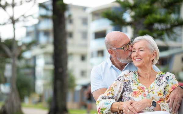 Happy older couple sitting in each other's arms and cuddling | Icon Cancer Centre